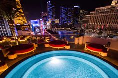 an indoor swimming pool in the middle of a city at night