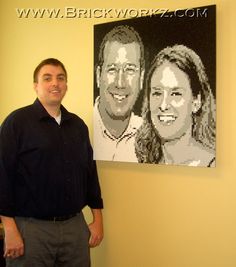 a man standing in front of a portrait made out of legos