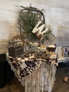 a table topped with lots of desserts on top of a white and brown table cloth