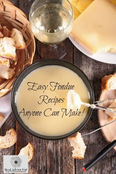 there is a bowl of soup on the table with bread and cheeses around it