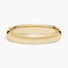 a yellow gold wedding ring on a white background