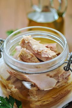 a jar filled with sliced meat sitting on top of a table