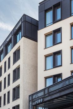 two tall buildings next to each other with windows