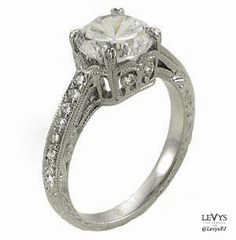 an engagement ring with a center stone and side stones on the sides, set in white gold