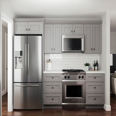 a kitchen with gray cabinets and stainless steel appliances, including an oven, refrigerator, microwave, dishwasher and stove