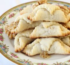 several pastries on a plate with walnuts