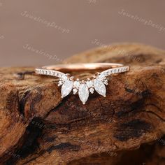 a diamond ring on top of a piece of wood