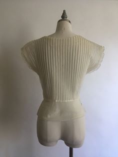 "Gorgeous sheer 1940's short sleeve nylon blouse with lace collar and rhinestones has pretty cap sleeves with a layer of pleated ruffle. Blouse zips up on the side and is in excellent vintage condition. Made by Debcraft and possibly one of the nicest nylon blouses I have come across! Shoulders 15\" Chest up to 36\" Waist 28\" Length from back of neck to hem 18\" Vintage garments have been previously worn and lovingly cared for, they may however have a blemish or two. Here at MadelonVintage, I tr Sheer Fitted Blouse For Daywear, Fitted Sheer Blouse For Daywear, Classic Sheer Evening Tops, Fitted Retro Cream Top, Sheer Short Sleeve Tops For Evening, Elegant Fitted Tops With Cap Sleeves, Sheer Lace Short Sleeve Top, Vintage Short Sleeve Blouse With Lace Collar, Fitted Lace Trim Blouse For Vintage Fashion