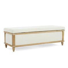 an upholstered bench with white fabric and wood trimmings, against a white background