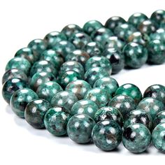 green and black beads on white background