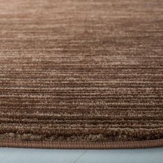 a close up view of a brown area rug