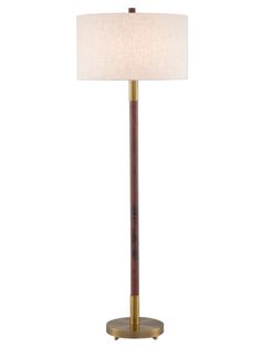 a lamp that is on top of a wooden stand with a white shade over it