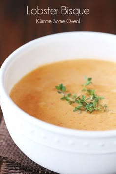 a white bowl filled with soup on top of a wooden table