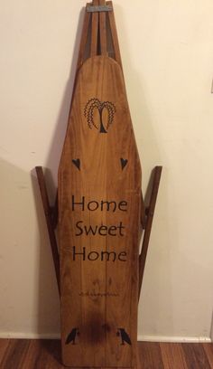 a wooden sled with the words home sweet home written on it in black ink