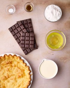 the pie is ready to be eaten with milk and other desserts around it on the table