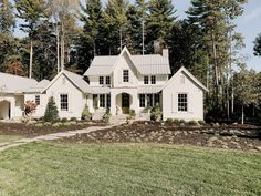 a large white house in the middle of some trees