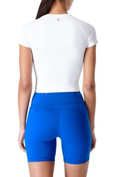 Work out or chill out in this stretchy crop T-shirt framed by sporty raglan sleeves. 14 1/2" center front length (size Medium) Crewneck Short sleeves 91% polyamide, 9% elastane Machine wash, tumble dry or line dry Imported Athleisure Stretch Cropped T-shirt With Short Sleeves, Go-dry Cropped Sports Top, Functional Sports Crop Top With Crew Neck, White Fitted Crop Top With Moisture-wicking, Functional Crew Neck Crop Top For Sports, Summer Sports Stretch Cropped T-shirt, Summer Sports Cropped T-shirt With Stretch, Stretch Cropped T-shirt For Sports In Summer, Breathable Stretch Cropped Tops