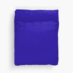 a bright blue bed sheet with white pillows