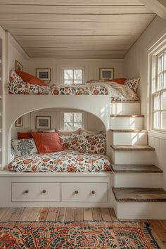 a bedroom with bunk beds and drawers under the stairs in front of them is shown