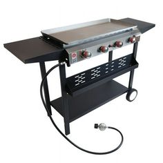 an outdoor gas grill with two burners on the side and a hose connected to it