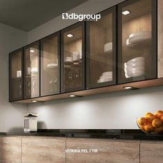 an image of a kitchen setting with glass cabinets and fruit bowl on the counter top