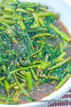 a white bowl filled with broccoli and sesame seeds on top of a table