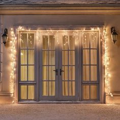 the front door is decorated with christmas lights