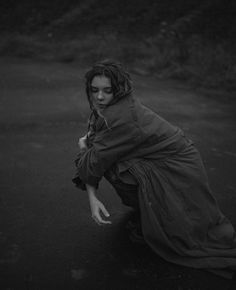 black and white photograph of a woman crouching down