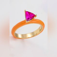 an orange ring with a pink triangle on it