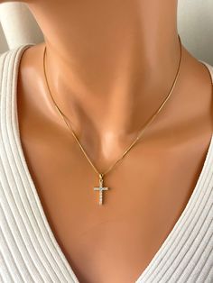 "This is 14kt gold filled crystal cross necklace. This lovely 14k gold filled box chain holds a 20x12mm, 14k gold filled cz cross charm that sparkles with tiny clear crystals. A spring clasp closure sits at the back of necklace.  Necklace may be ordered in a 16\", 18\" or 20\". Please note if you order 20 inch length you'll receive an 18 to 20 inch adjustable chain. Model has a small neck is wearing a 16 inch length." Dainty Cubic Zirconia Cross Jewelry, Dainty Cross-shaped Cubic Zirconia Jewelry, Dainty Cross Jewelry In Cubic Zirconia, Cubic Zirconia Crucifix Necklace For Gift, Gold Cubic Zirconia Cross Necklace As A Gift, Gold Plated Cross Necklace As A Gift, Cubic Zirconia Crucifix Jewelry Gift, Cross Charm Necklace, Cross Necklaces