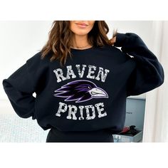 This distressed ravens sweatshirt perfect to show your school spirit or love of the game! Makes a great gift for the ravens mom! This distressed raven design is perfect on the popular Gildan brand sweatshirt. This vintage style sweatshirt will keep you warm throughout the season!  A pre-shrunk, classic fit sweater that's made with air-jet spun yarn for a soft feel and reduced pilling. ** P R O D U C T **  - 50% cotton, 50% polyester  - Pre-shrunk  - Classic fit  - Direct to Garment print (no ste Black Team Spirit Sweatshirt For College, Black School Spirit Sweatshirt For Sports Events, University Logo Fan Apparel Sweatshirt, School Spirit Sweatshirt With Screen Print For Fans, Black Sports Fan Graphic Sweatshirt, University Logo Cotton Sweatshirt For Fan Gear, University Logo Cotton Sweatshirt For Fans, University Logo Cotton Sweatshirt Fan Gear, Black Graphic Print Sports Fan Sweatshirt