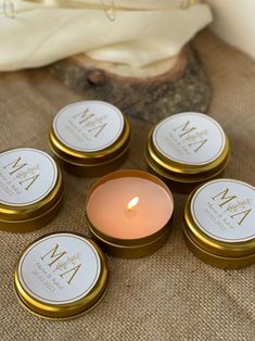 six personalized candles sitting on top of a table