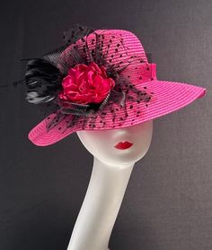 The featured hat is a fuchsia  straw hat with a black crinoline flower, black netting, black feathers and a fuchsia center fabric flower. This hat is so eye popping and gorgeous  it's a must have for any woman who loves hats. This  hat is a beautiful church hat or a Kentucky Derby Hat.  Also perfect  for an Easter Hat, Tea Party hat,Wedding Party Hat, Fancy Dress Hat , Downton Abby hat and any other special occasion. Brim:   3" Rise:   4" Size:   22" Pink Brimmed Hat For Church, Pink Short Brim Sun Hat For Church, Pink Brimmed Mini Hats For Formal Occasions, Pink Curved Brim Top Hat For Church, Fitted Pink Sun Hat For Kentucky Derby, Pink Fitted Sun Hat For Kentucky Derby, Pink Sun Hat For Kentucky Derby, Pink Top Hat For Church In Spring, Pink Sun Hat For Spring Party