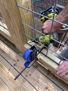 a man using a power drill to nail wood