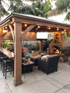 an outdoor patio covered with furniture and lights