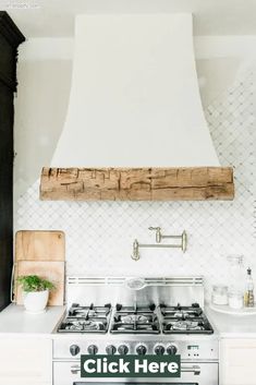 a stove top oven sitting inside of a kitchen next to a wall mounted range hood