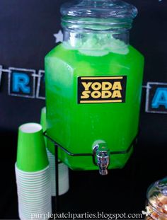 a green beverage dispenser sitting on top of a table