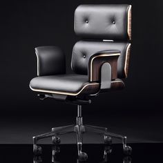 an office chair with black leather upholstered on the back and armrests