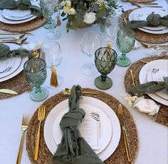 the table is set with place settings, napkins and silverware for an elegant dinner