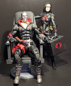 two action figures sitting in chairs with guitars