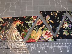 three pieces of fabric are laid out on a cutting board with a ruler next to them