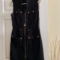 Adorable Black Sleeveless Dress By Calvin Klein. Dress Has As Zipper At The Top Of Dress And Another On The Bottom With Gold Design. Two Breast Pockets And Two Hip Pockets With Gold Hardware. Also A Hidden Elastic At Waist To Tighten Or Loosen. Great Dress For The Coming Season. No Tags But Never Worn. Black Sleeveless Mini Dress With Pockets, Black Sleeveless Dress For Fall, Casual Knee-length Sleeveless Dress By Calvin Klein, Casual Calvin Klein Knee-length Sleeveless Dress, Chic Calvin Klein Black Mini Dress, Chic Black Calvin Klein Mini Dress, Calvin Klein Black Chic Mini Dress, Calvin Klein White Dress, White Knee Length Dress