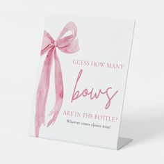 a greeting card with a pink bow on the front says guess how many bows are in the bottle?