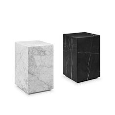 two black and white marble cubes sitting next to each other