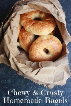 three bagels sitting in a brown paper bag