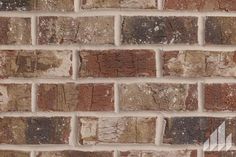 a brick wall that has been painted brown and white