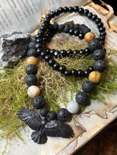 The Crow is the guardian of magic and healing 🖤 Large 12mm lava and agate beads were used to create this necklace in addition to smaller black wooden beads. Lava beads are spiritual and believed to bring a sense of security and protection as well as healing physical body aches and pains, relieving emotional and mental suffering, and heightening spiritual growth. It is commonly used as a diffuser for essential oils and during meditations. Agate transforms negative energy into positive energy. Agate enhances mental function, improves concentration, enhances perception and analytical abilities. It is a soothing and calming gemstone that heals inner anger, anxiety and helps in the strengthening of relationships. Agate instills security and safety. Pagan Pendants, Crow Pendant, Deer Antlers Necklace, Body Aches, Crust Punk, Antler Necklace, Gifts For My Girlfriend, Lava Beads, The Crow