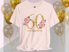 a t - shirt with the number sixty and flowers on it next to some balloons