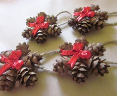 pine cones tied to twine with red bows