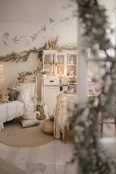 a bedroom with white furniture and decorations on the walls, along with lights strung from the ceiling